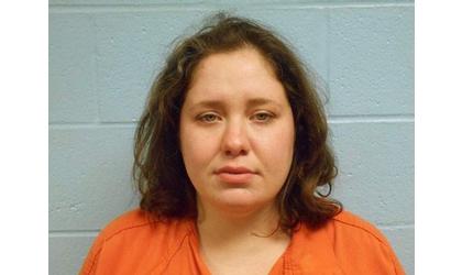 Woman charged in parade deaths