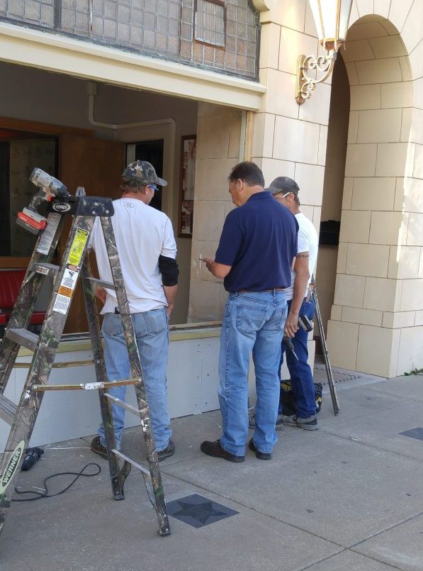 Workers replacing windows at The Poncan Theatre