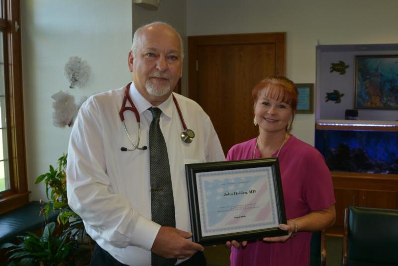 Dr. John Holden recognized as business partner of the month